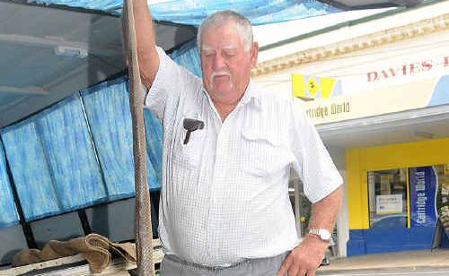 Peter Rogers holds the big brown snake he found dead at his back door. Peter Rogers holds the big brown snake he found dead at his back door.